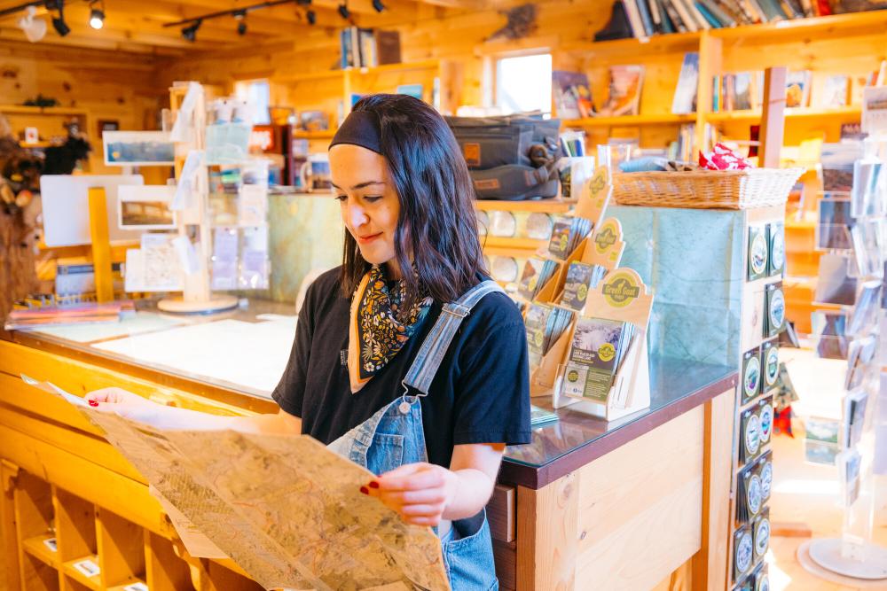 A woman looks at a map in a gear store