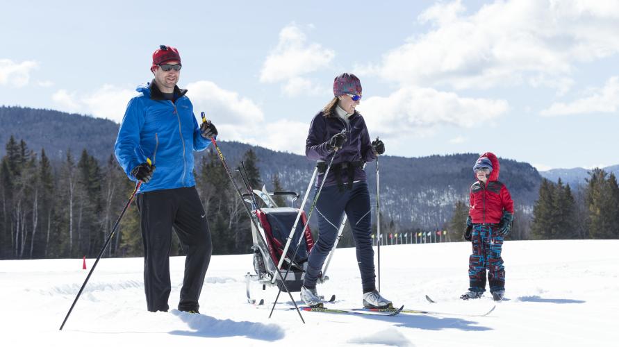 A family cross-country skiing at Mt. Van Hoevenburg