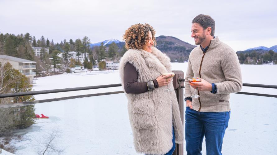 A couple drinking on patio in the winter