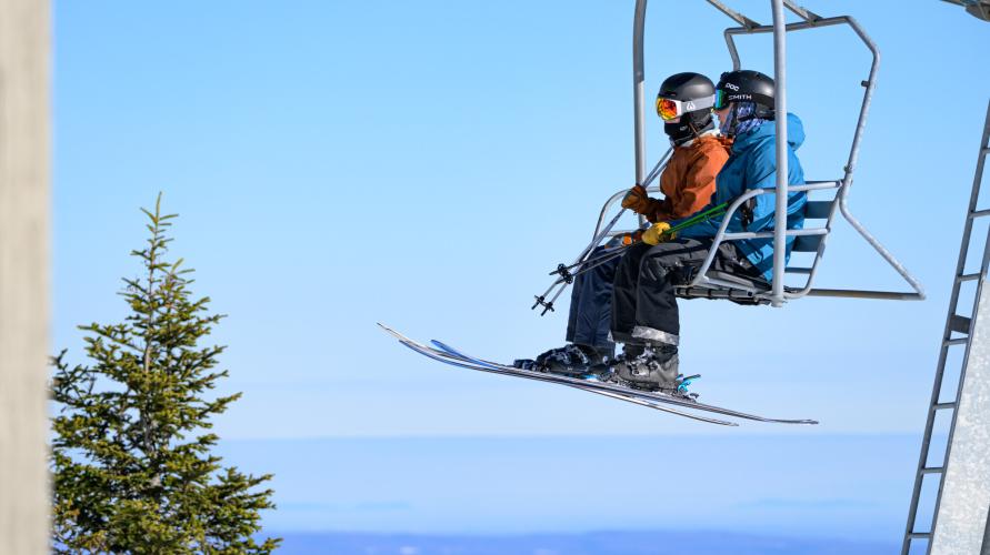 Skiers on a chair lift