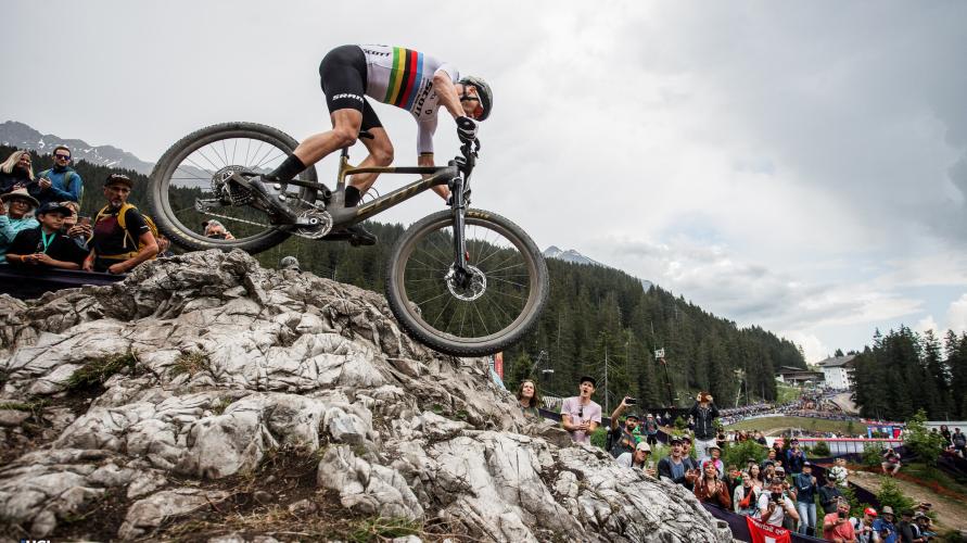 A mountain biker descends a rocky outcrop