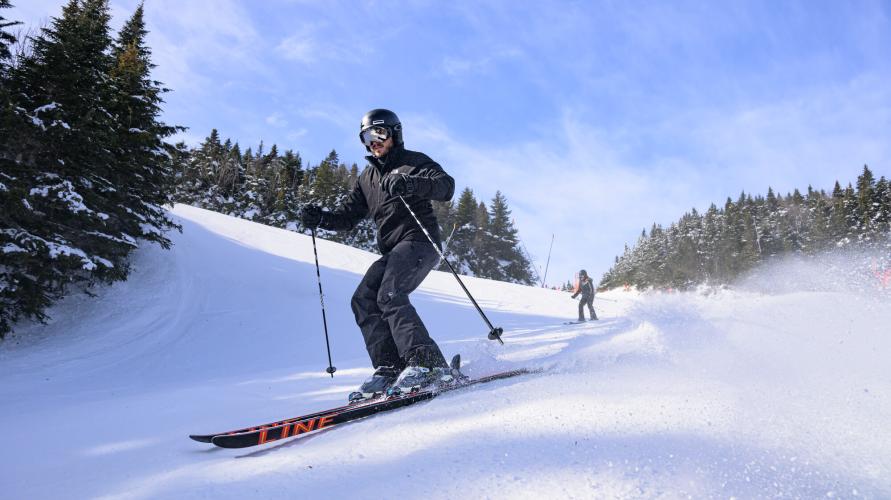 A person skiing down a trail at Whiteface Mountain.