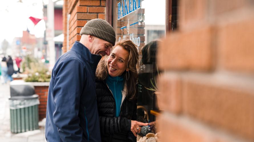 A couple looking through the window of a shop on Main Street in Lake Placid.