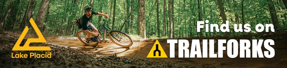 A banner for Trailforks with a man riding a bike.