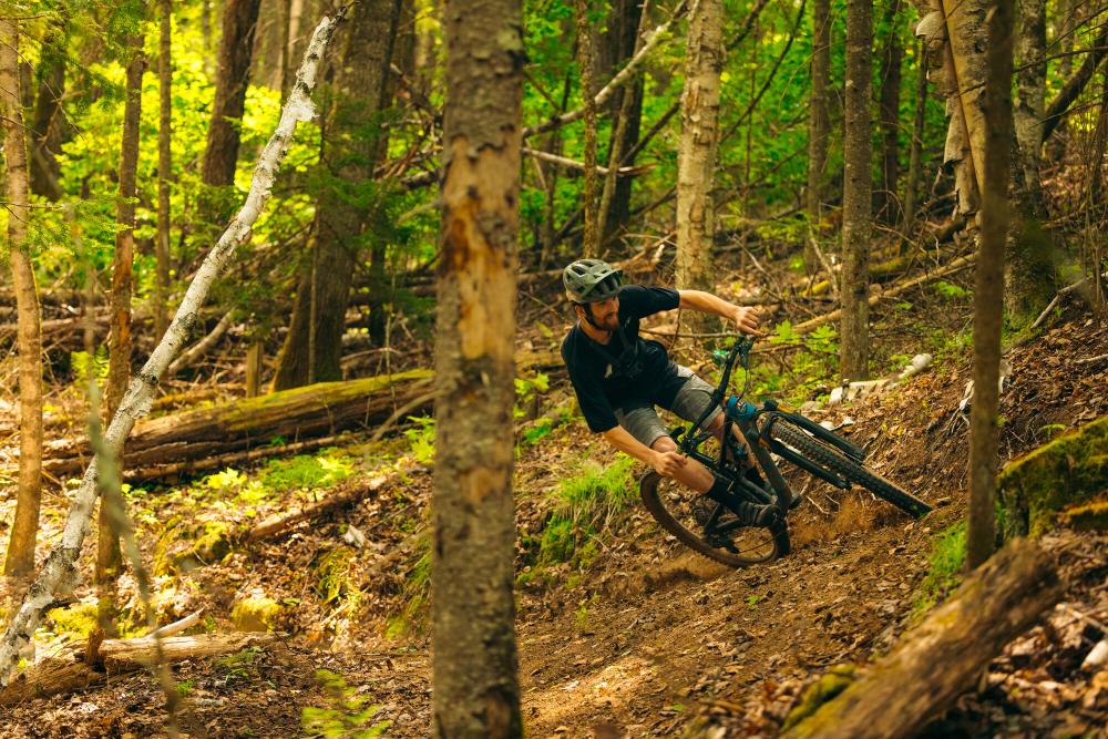 A man makes a sharp turn on a mountain bike.