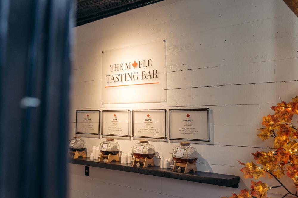 Maple Tasting Bar with small glass barrels of maple syrup