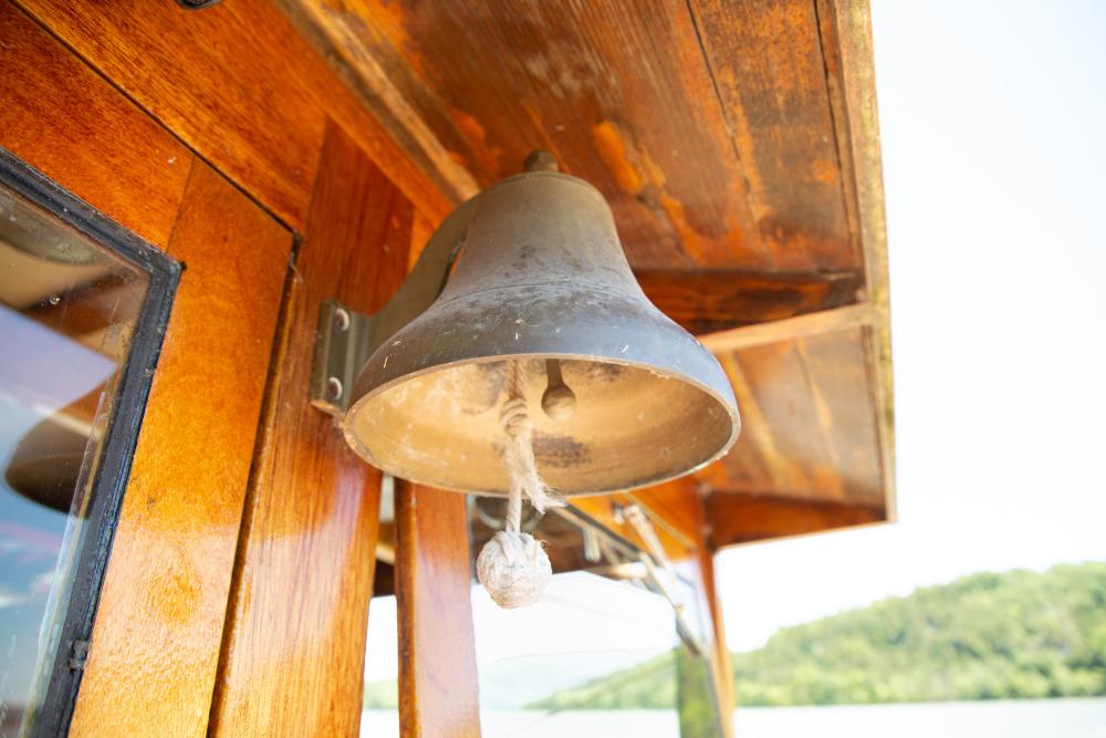 A bell hanging from an overhang.