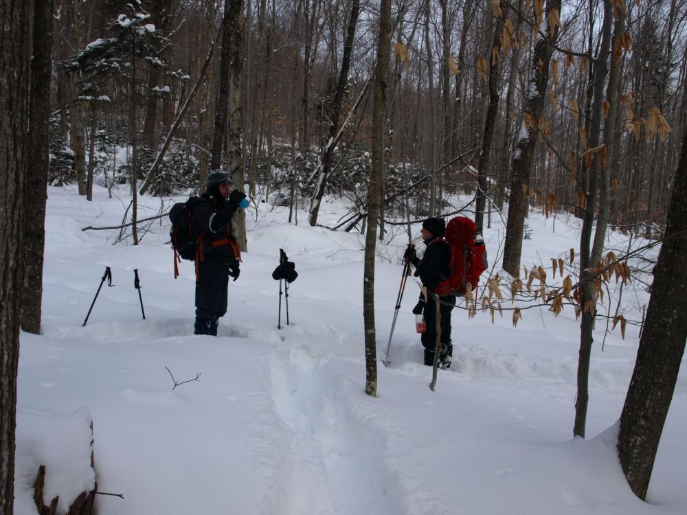 A quick break and grabbing some fluids on a demanding part of the hike