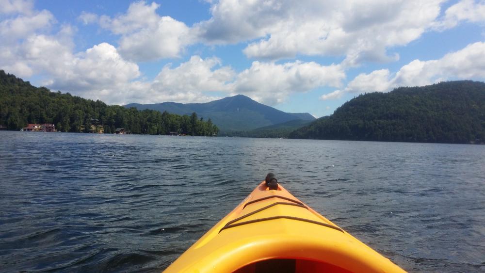 A kayak on Lake Placid lake. Whiteface Mountain is in the background.