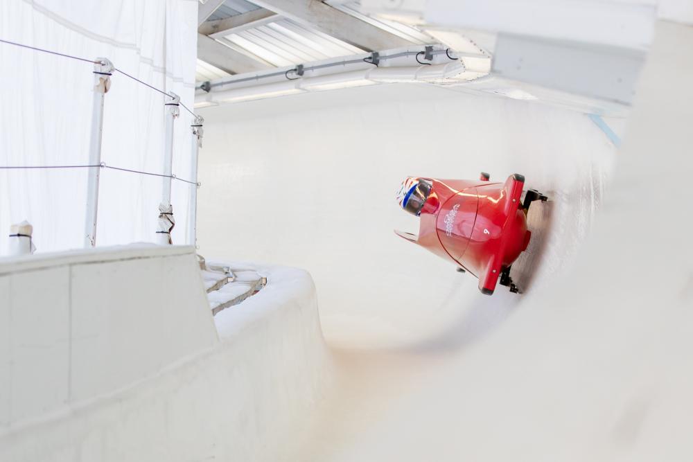 An adaptive bobsledder makes his way down the bobsled track in Lake Placid