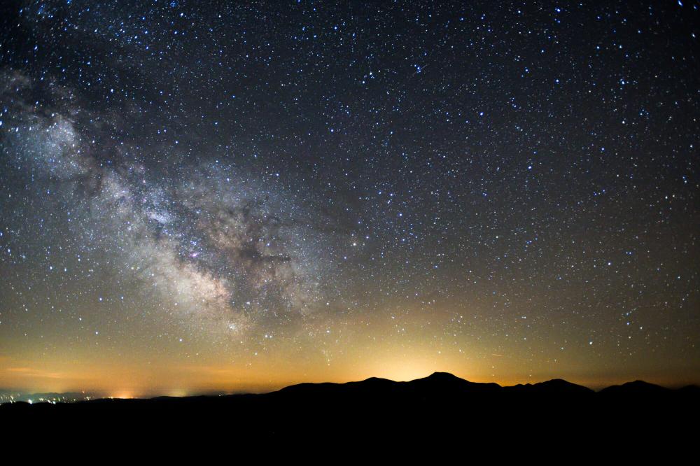 A mountain range silhouette at night.