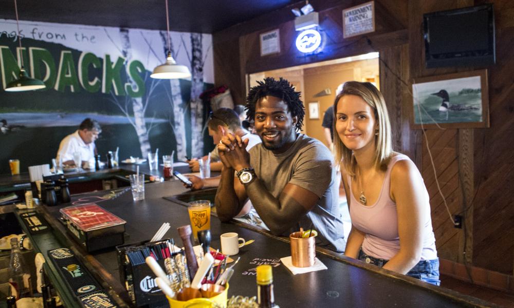 two people eating at the bar