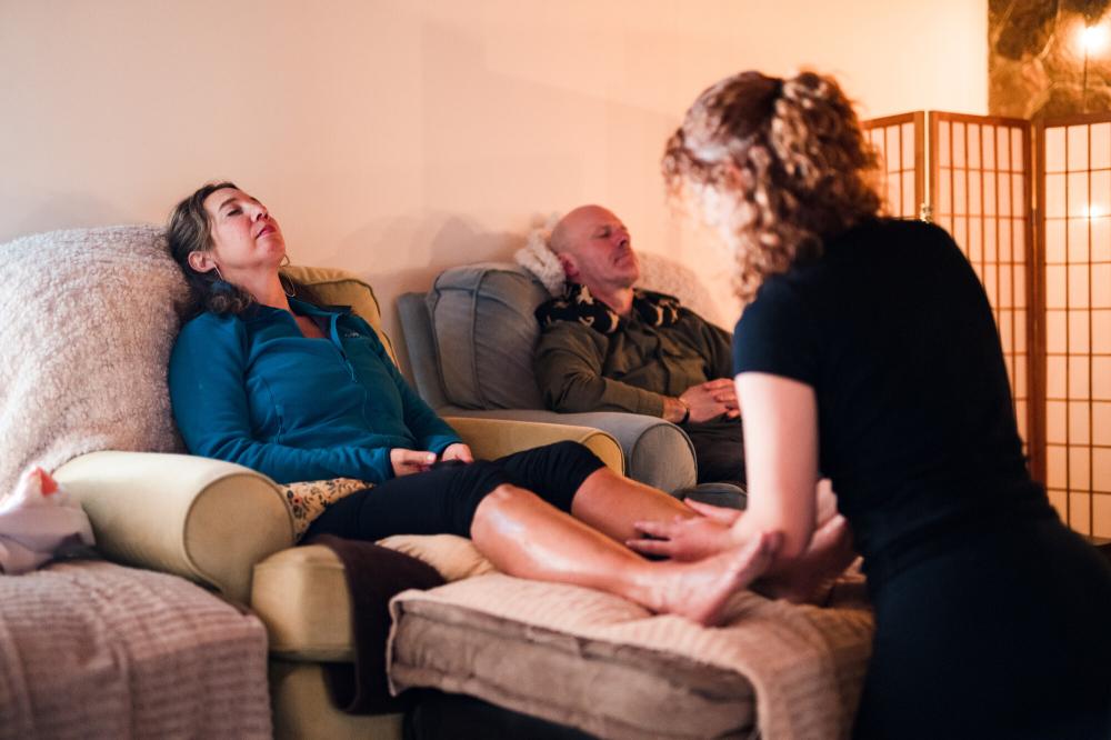 A woman has her feet massaged at a spa.