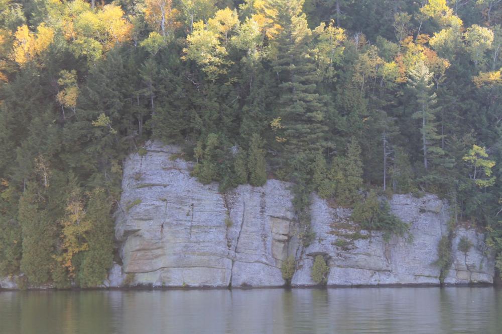 A white rock slab that leads into water.