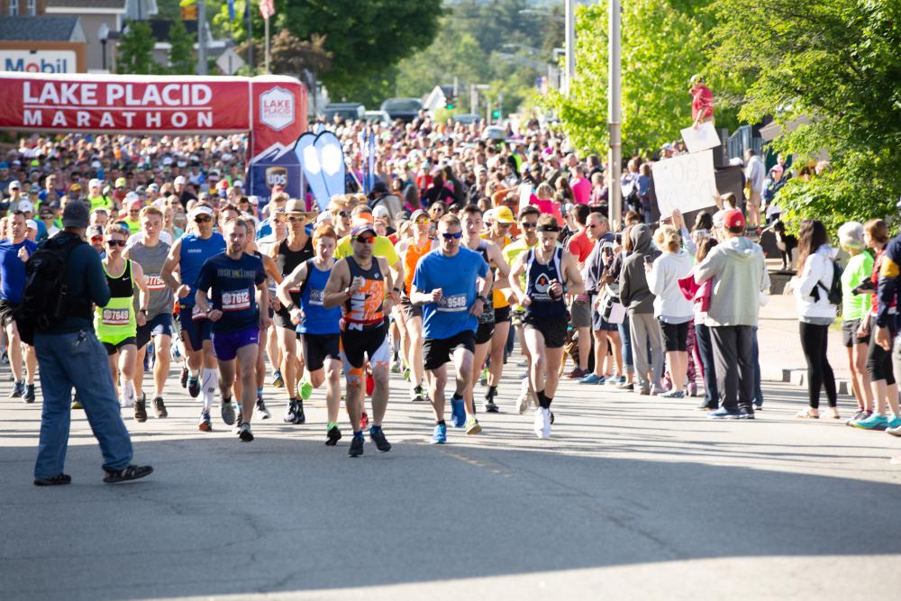 a large crowd of runners start the Lake Placid Marathon.