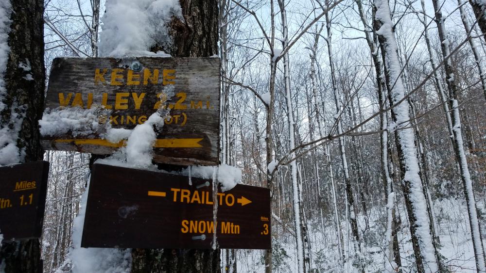 A sign in the winter for Snow Mountain