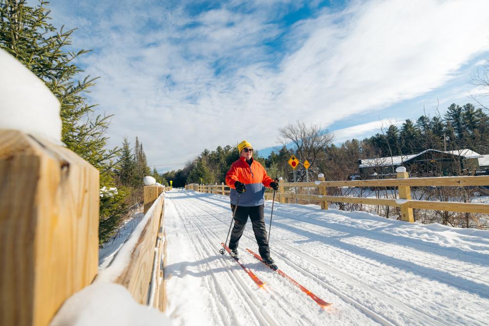 A woman cross-country skiing on the Adirondack Rail Trail