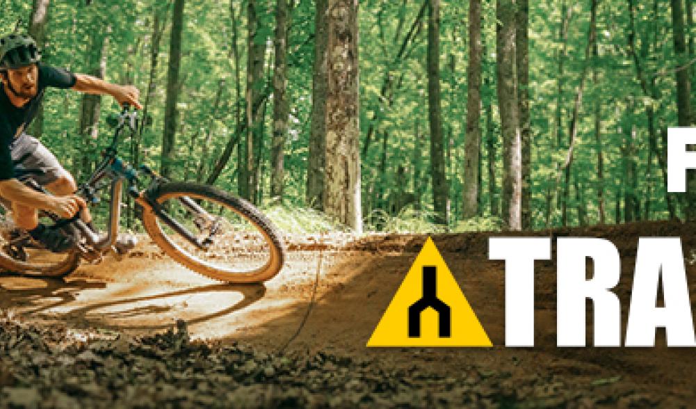 A banner for Trailforks with a man riding a bike.