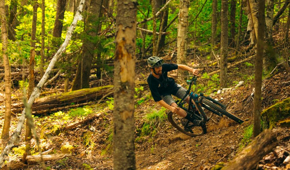 A man makes a sharp turn on a mountain bike.