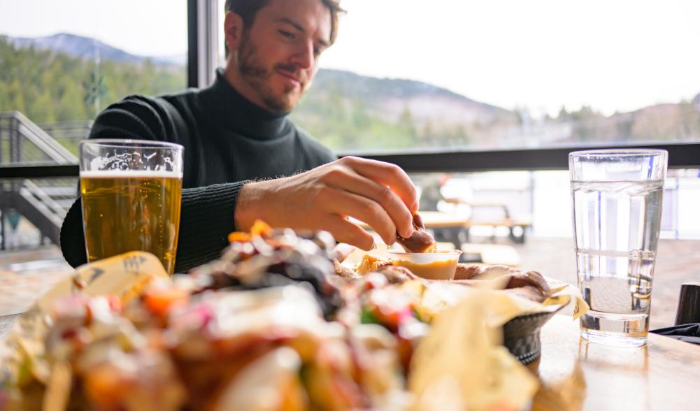 Dining on some nachos and pretzels in a ski lodge