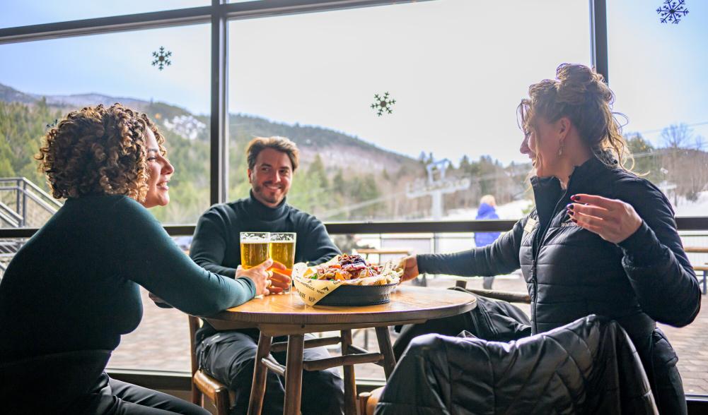 A group of people at a table in a ski mountain's dining area