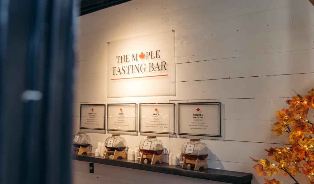 Maple Tasting Bar with small glass barrels of maple syrup