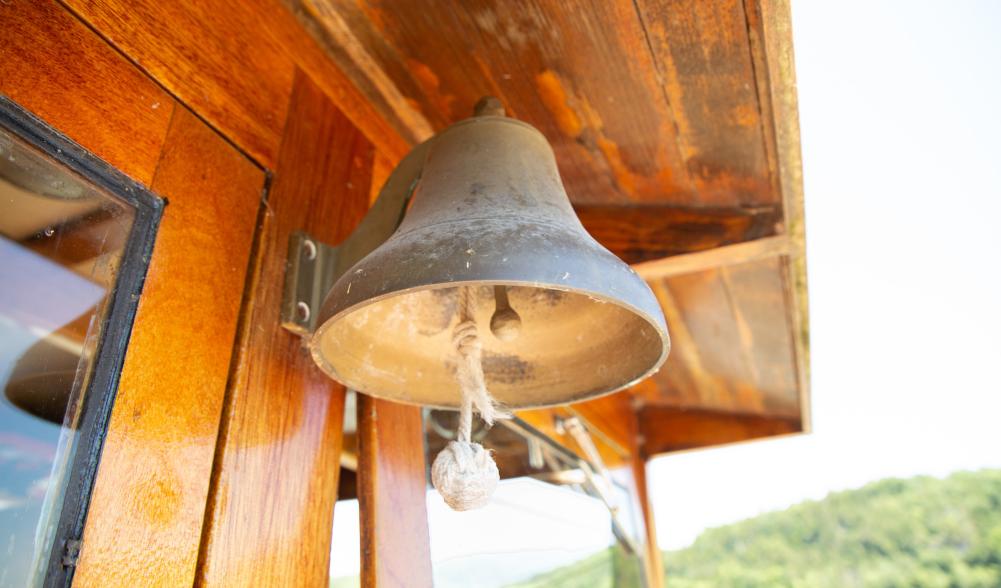 A bell hanging from an overhang.