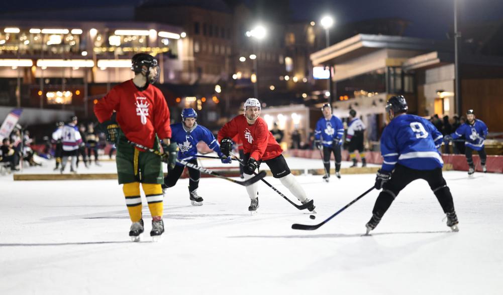 Pickup hockey teams play under the bright outdoor lights of the Lake Placid Olympic Center.