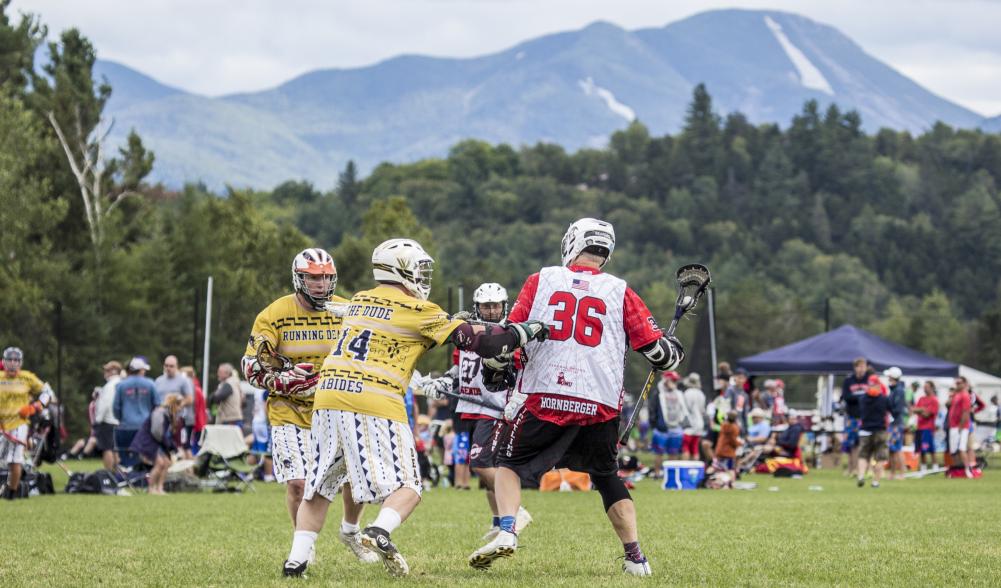 lacrosse players try to get the ball in front of High Peaks.