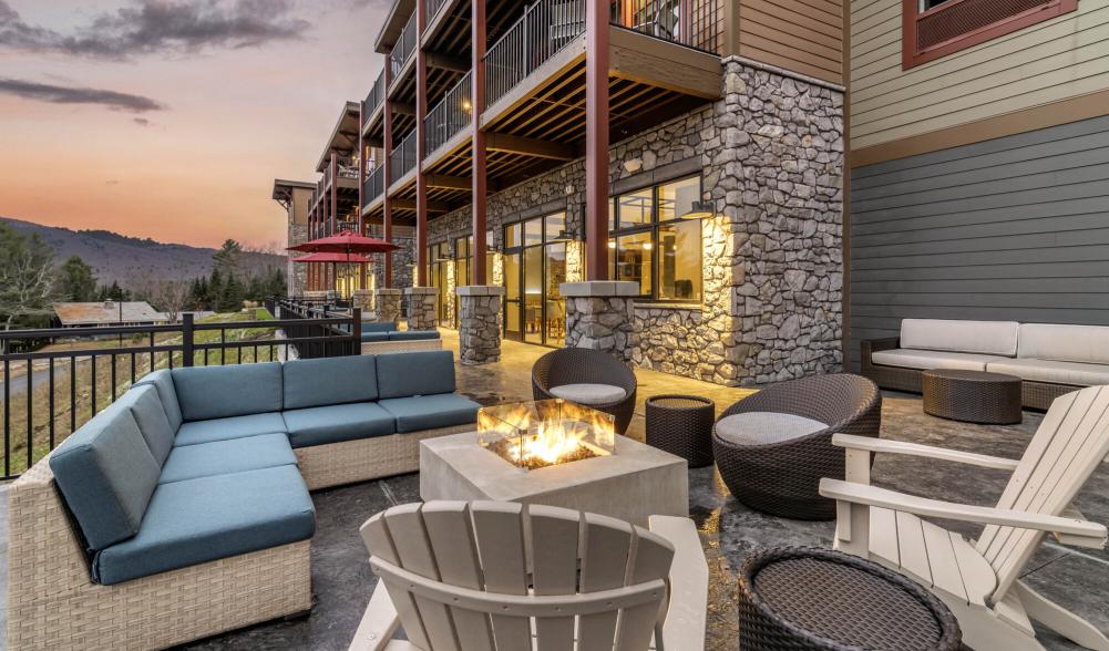 The stylish exterior deck with lounge furniture at a hotel.