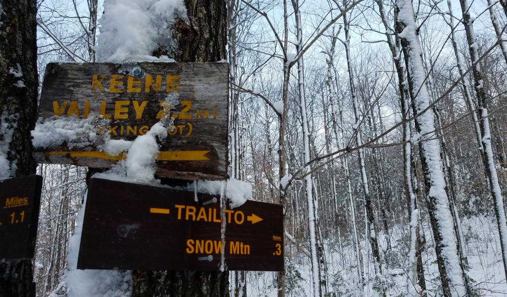 A sign in the winter for Snow Mountain