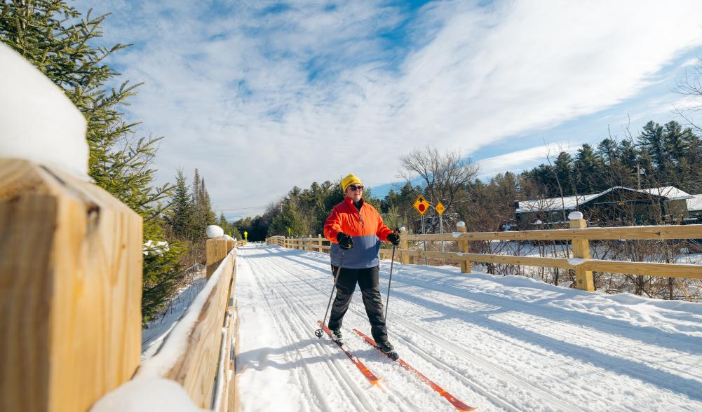 A woman cross-country skiing on the Adirondack Rail Trail