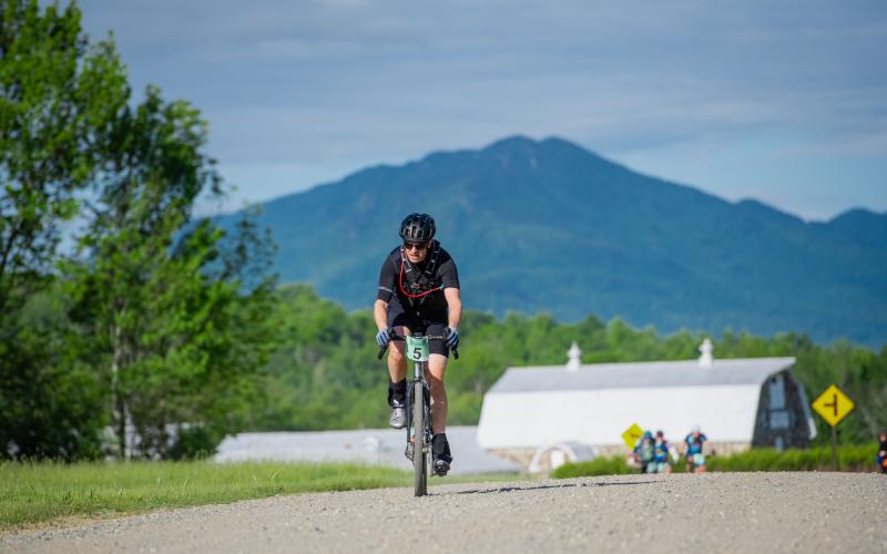 Bike racer on road with mountain in background