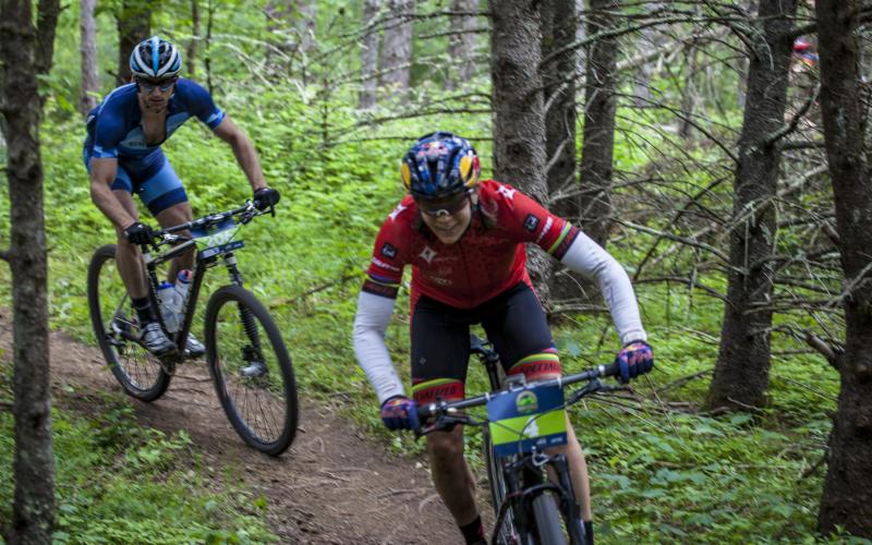 Mountain Bikers racing on forest trail