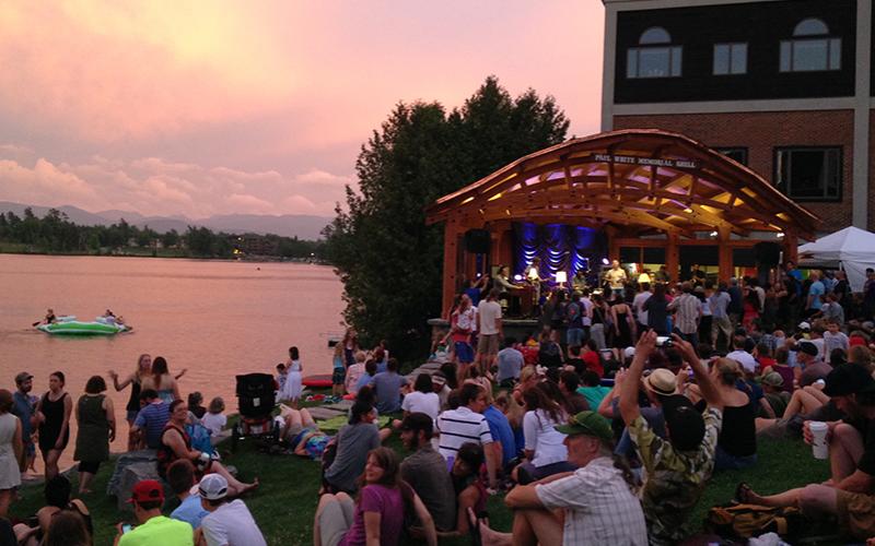 Sunset over Mirror Lake as crowd watchings a live music performance from Mid's Park