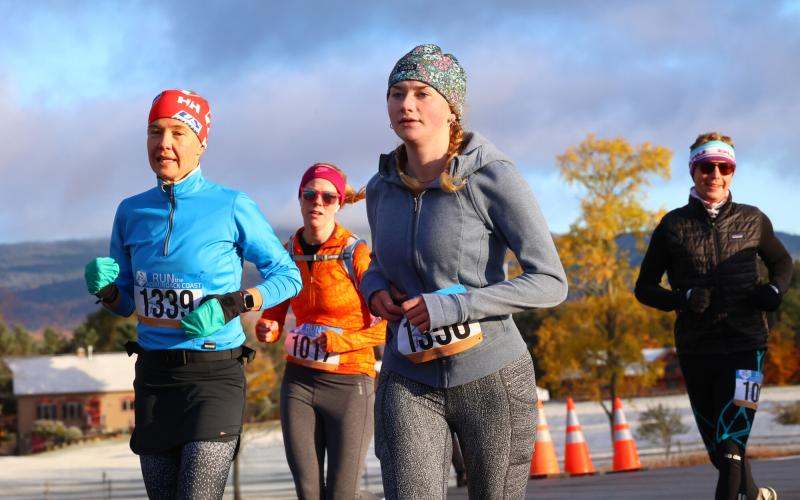 Four runners wearing warm clothes