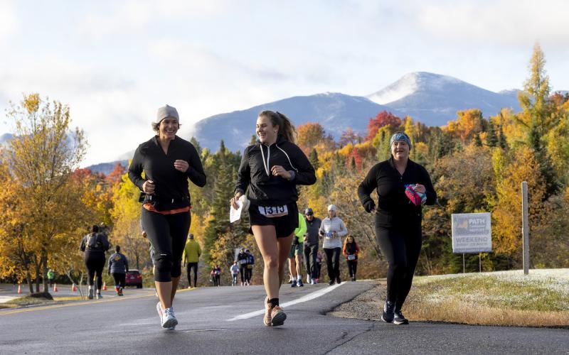 Trio of runners during race with mountains in background