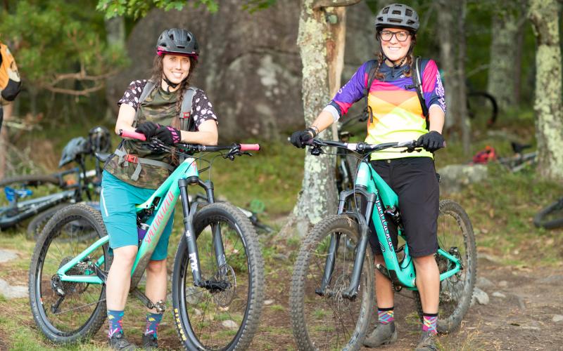 Smiling faces on matching teal bikes