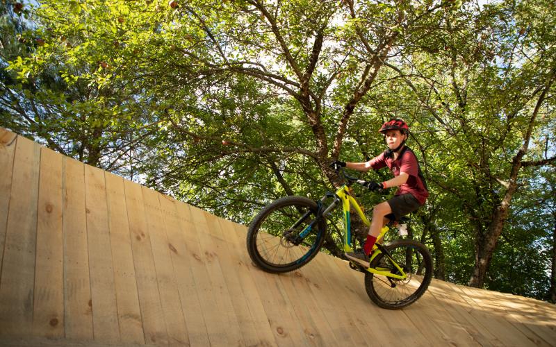 riding up a big wall in the woods