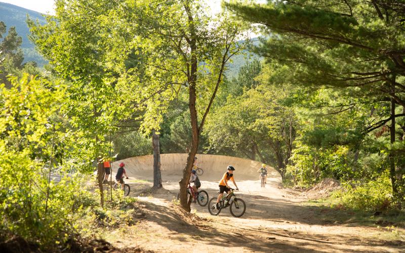 Big burm wall in the woods with young kids practicing