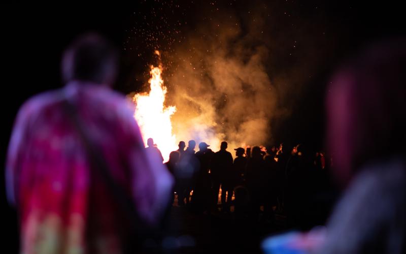 Backed up view of the crowd in front of the bonfire