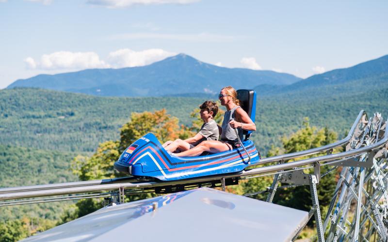 Mother and child riding mountain coaster