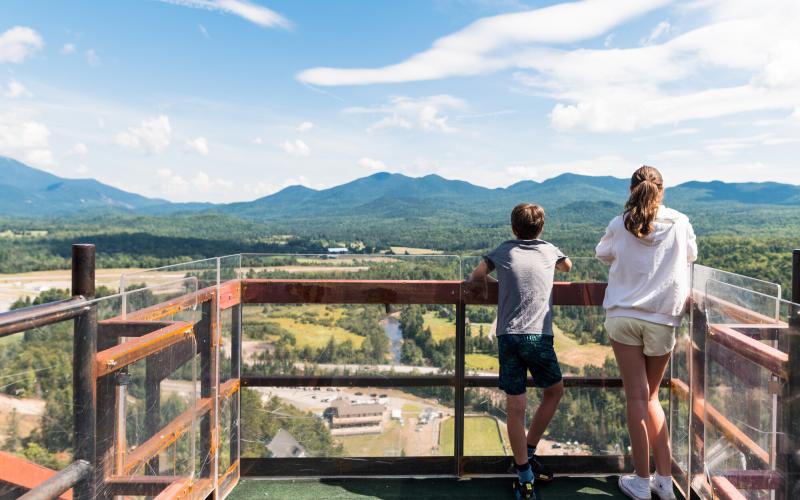 Mother and child on top of ski jumps enjoying view