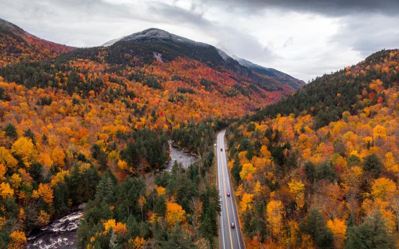 An aerial view of a mountain pass road in the fall