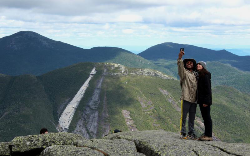 Two people taking a selfie on a mountain