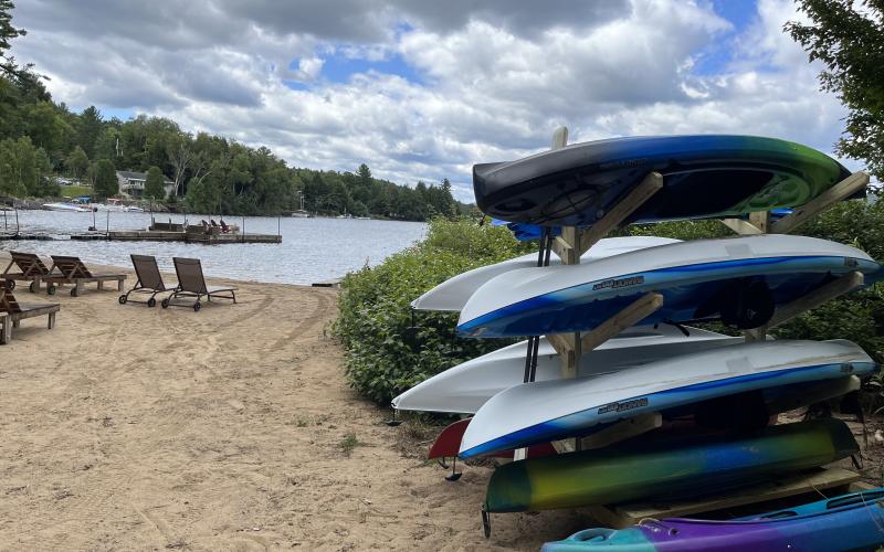 Stack of boats and Paddle Boards on a sandy beach