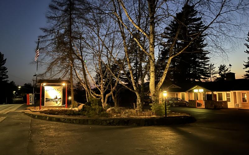 warm lights glow outside the property at dusk