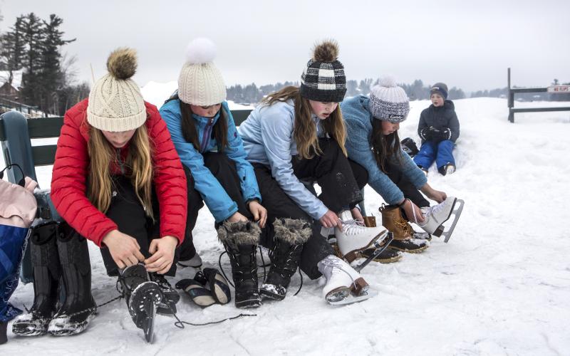 Putting skates on by Mirror Lake