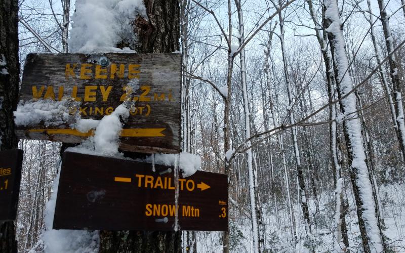 A wooden sign for Snow Mountain