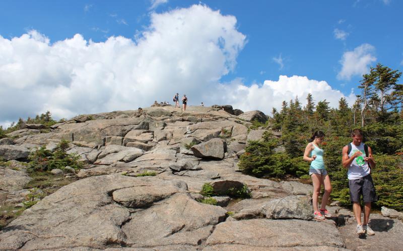 Hikers make their way down Cascade's summit.